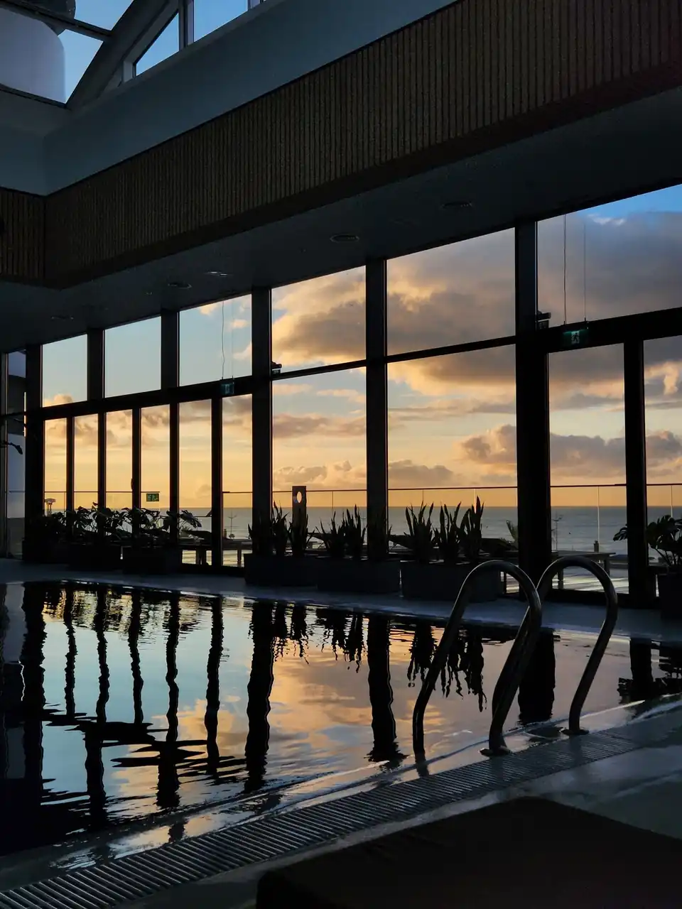 Serene indoor pool overlooking a sunset
