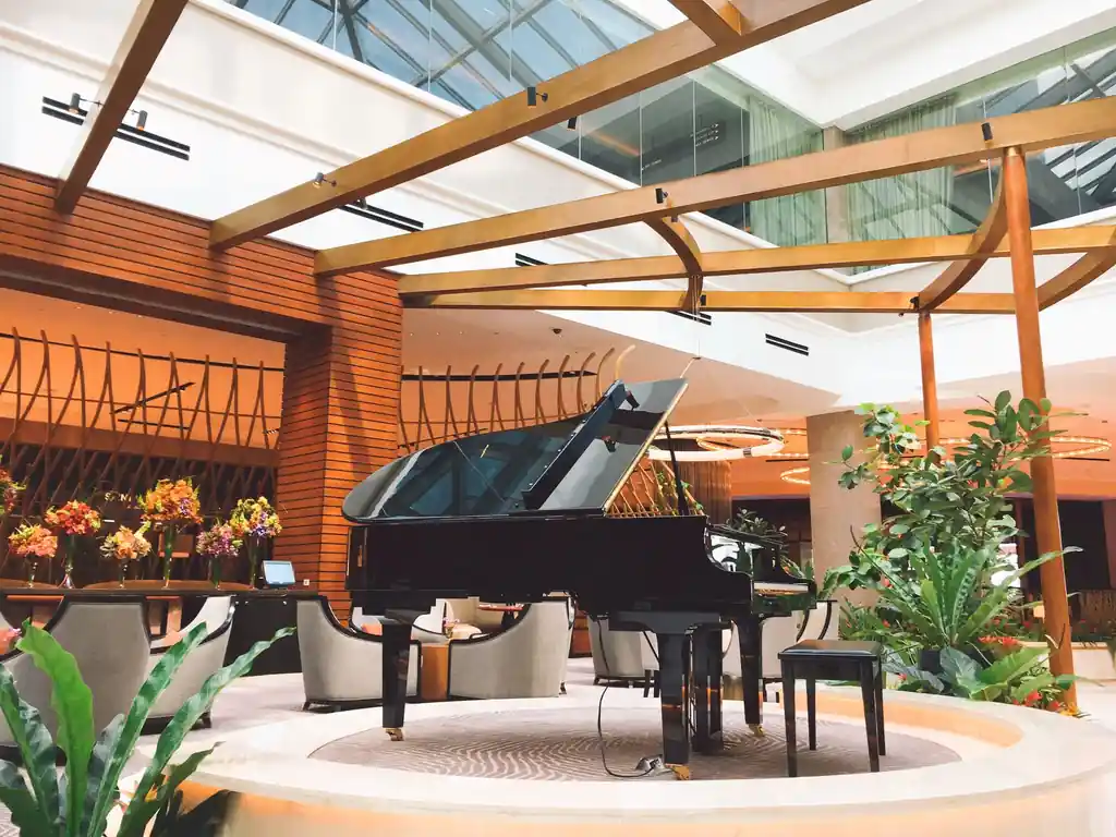 Elegant evening lounge at Trevessian Royal Manor featuring a grand piano and sophisticated interiors