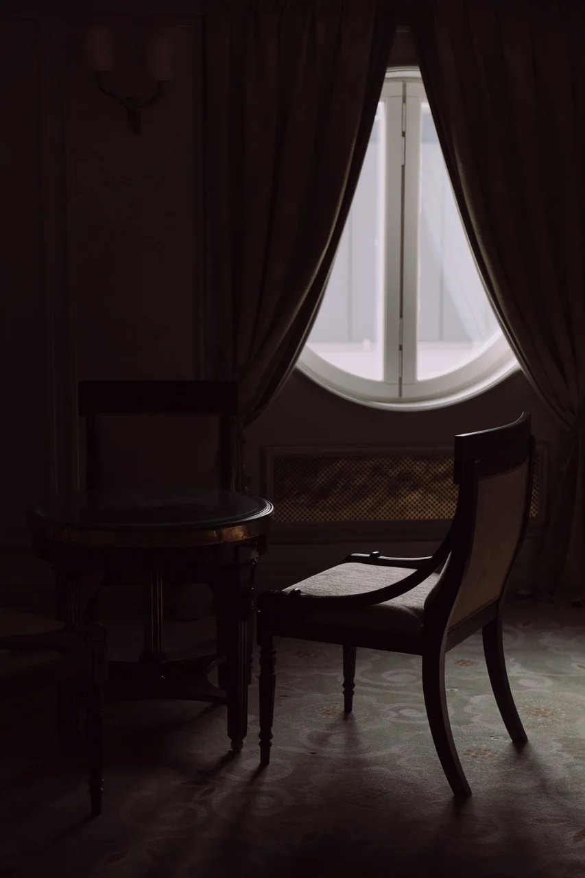 Luxurious suite at Trevessian Royal Manor featuring arched windows and elegant wood furniture