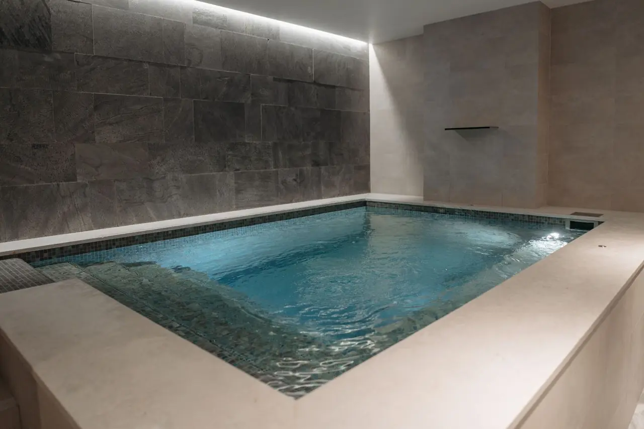 Elegant indoor spa pool with modern stone tile